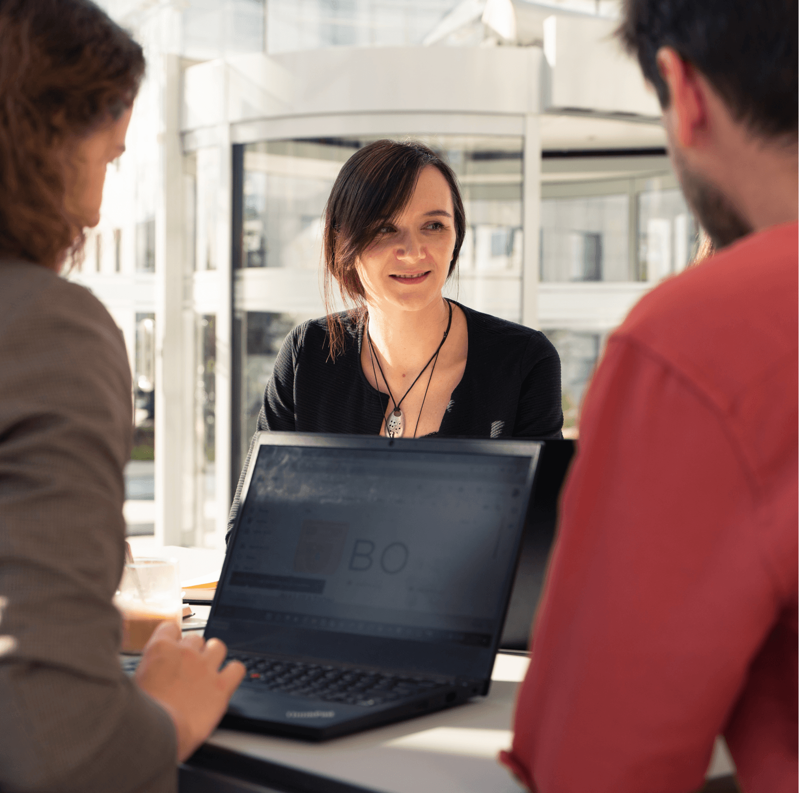 Three coworkers are discussing a project